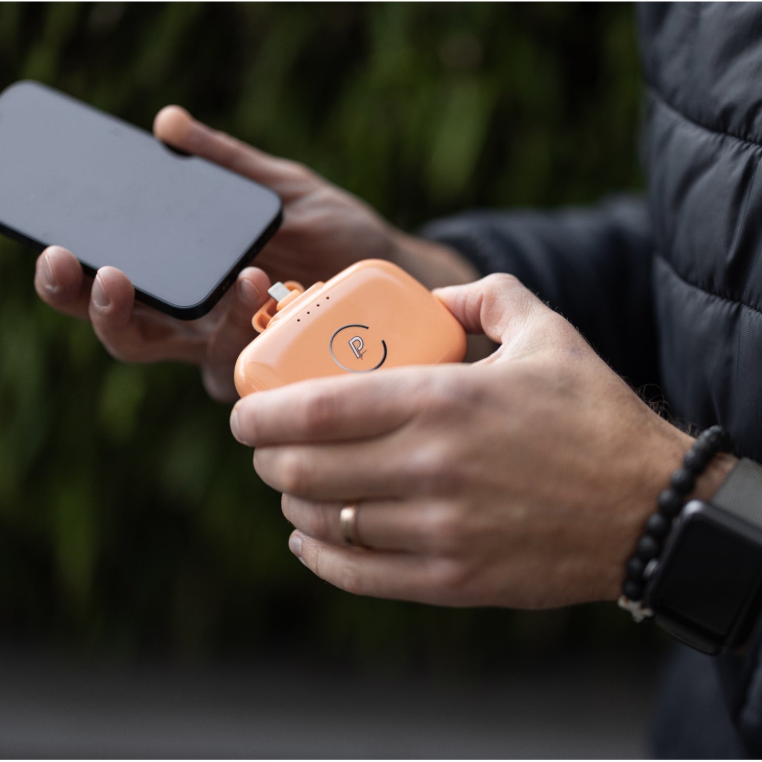 Gravity Portable Charger Charging Phone Shown in Coral Reef